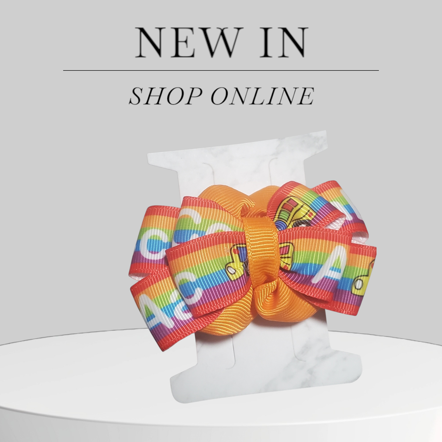 Orange Hair Bow with Vibrant Alphabet Design